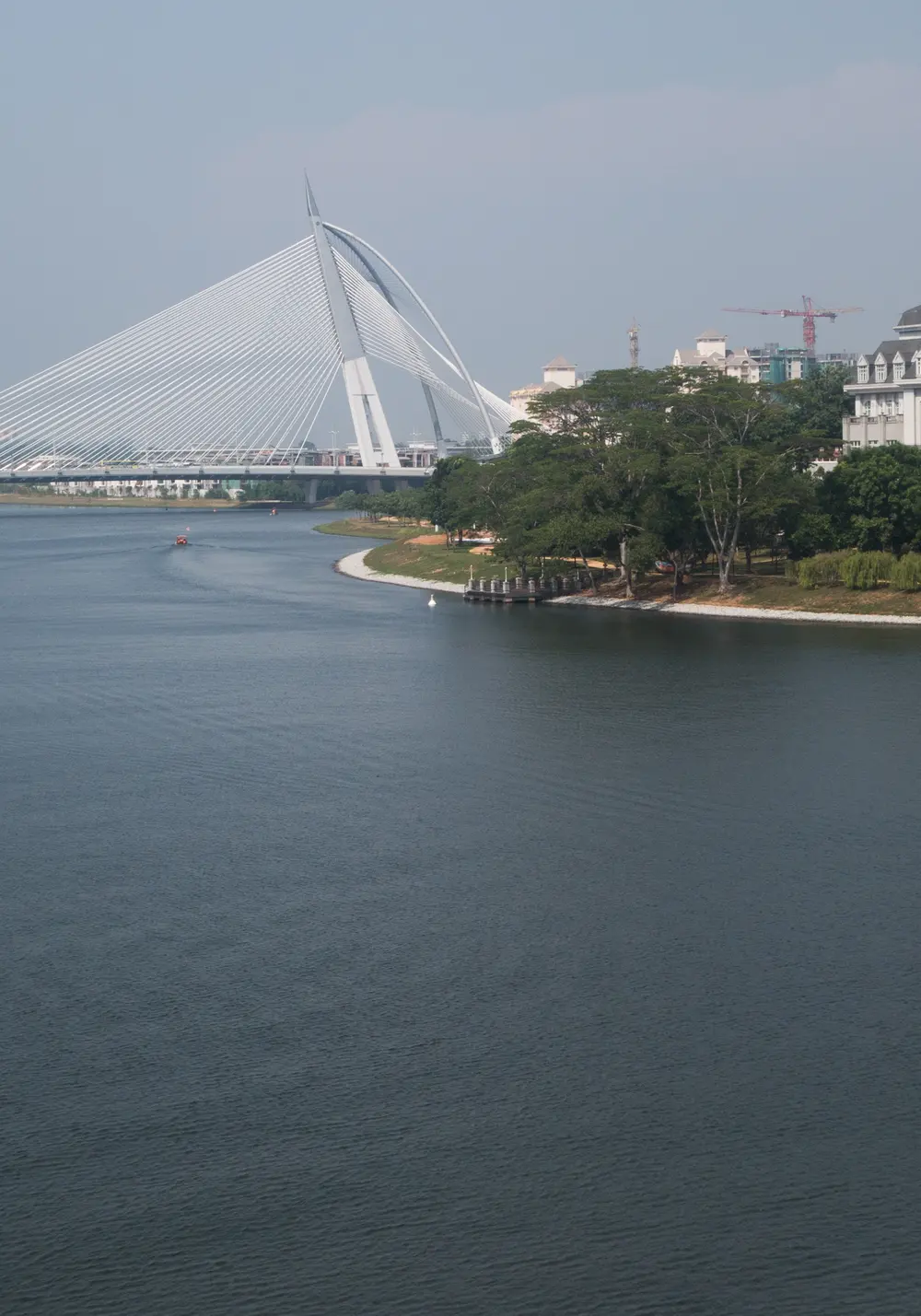 The Seri Wawasan Bridge and a calm lake in Putrajaya, Malaysia