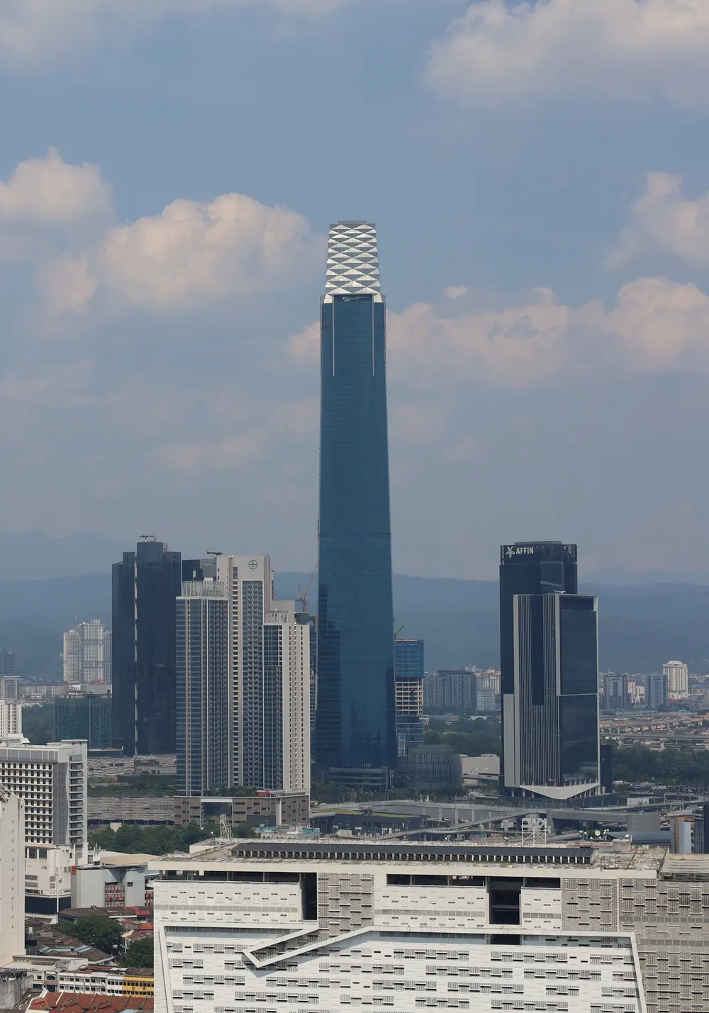 Modern glass towers of Kuala Lumpur's Exchange 106 business district rising above the city