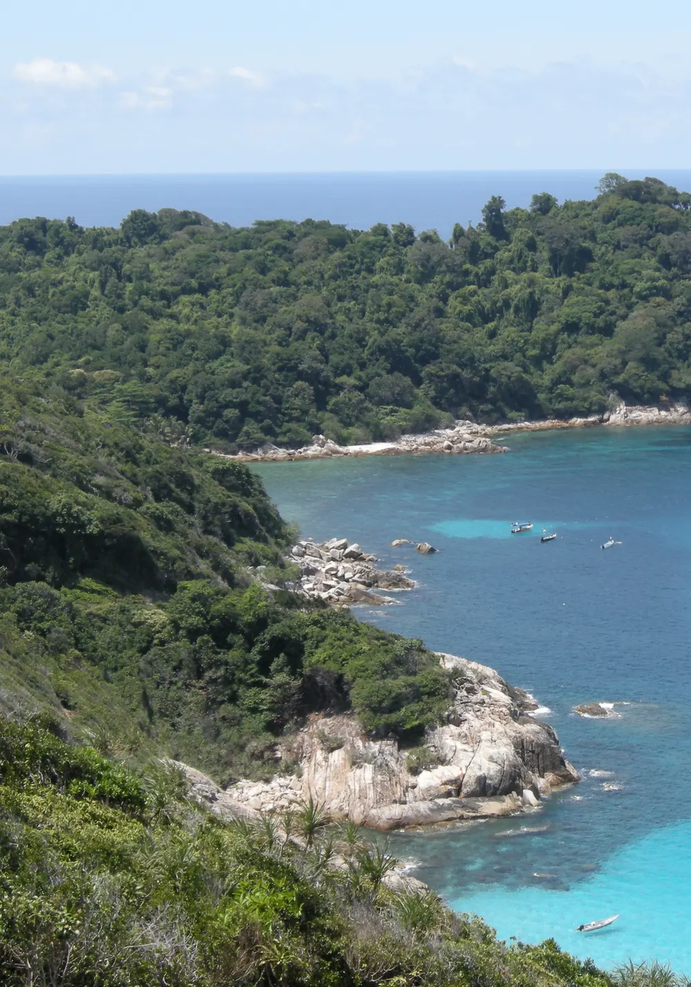 Turquoise sea and a forested headland on the Perhentian Islands, Malaysia