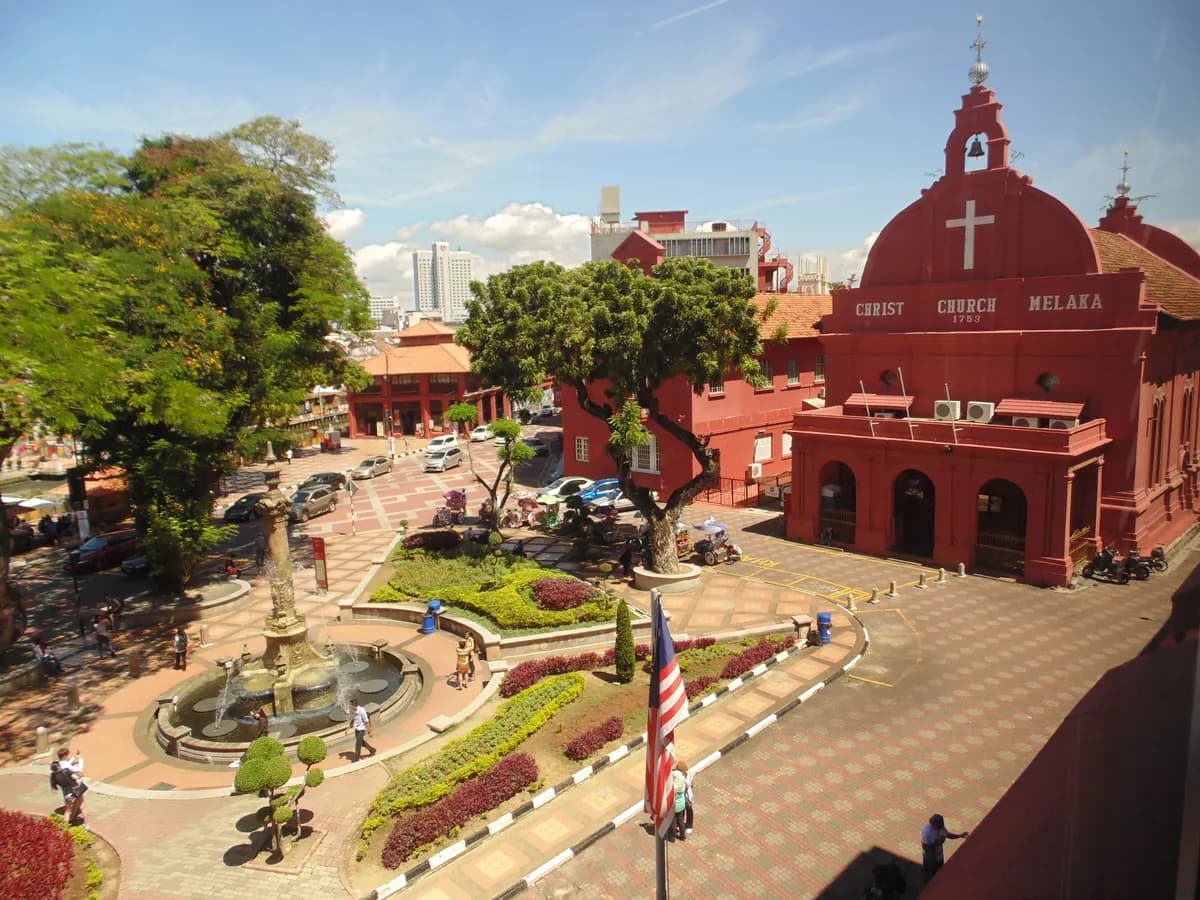 Dutch Square in Melaka seen from above: the red Christ Church and Stadthuys buildings, the fountain, flower beds and the Malaysian flag
