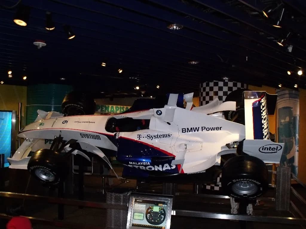 A Formula One car on display in a dimly lit exhibition hall at Petrosains, The Discovery Centre in Kuala Lumpur