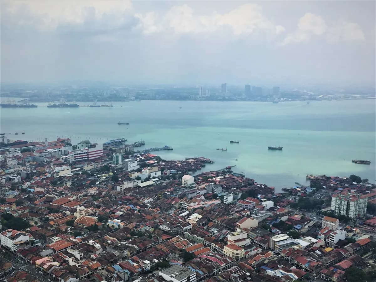 Aerial view from Komtar of George Town’s Weld Quay waterfront and the Clan Jetties beside the South Channel, with shophouse roofs in the foreground
