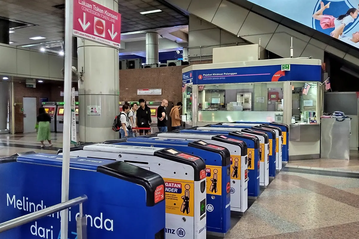 Ticket gates and a customer service counter on the LRT concourse at KL Sentral, Kuala Lumpur’s main rail interchange